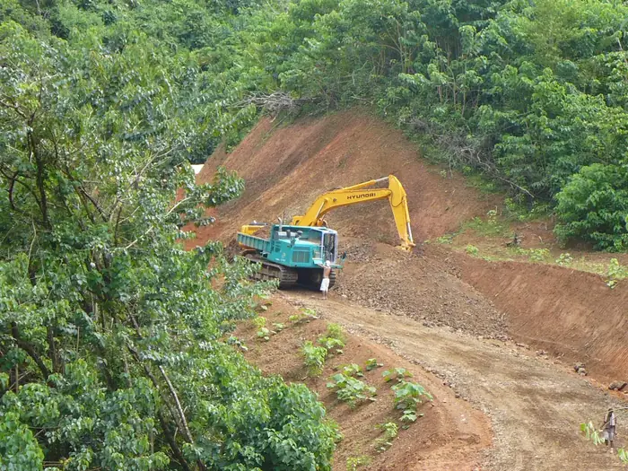 December 2007: hillside road opened with an excavator and a tracked dump truck.