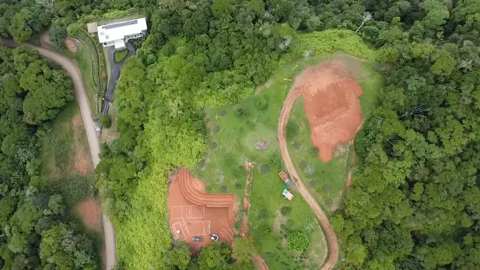 September 2026: the same property from the air, with the internal road and two pads.